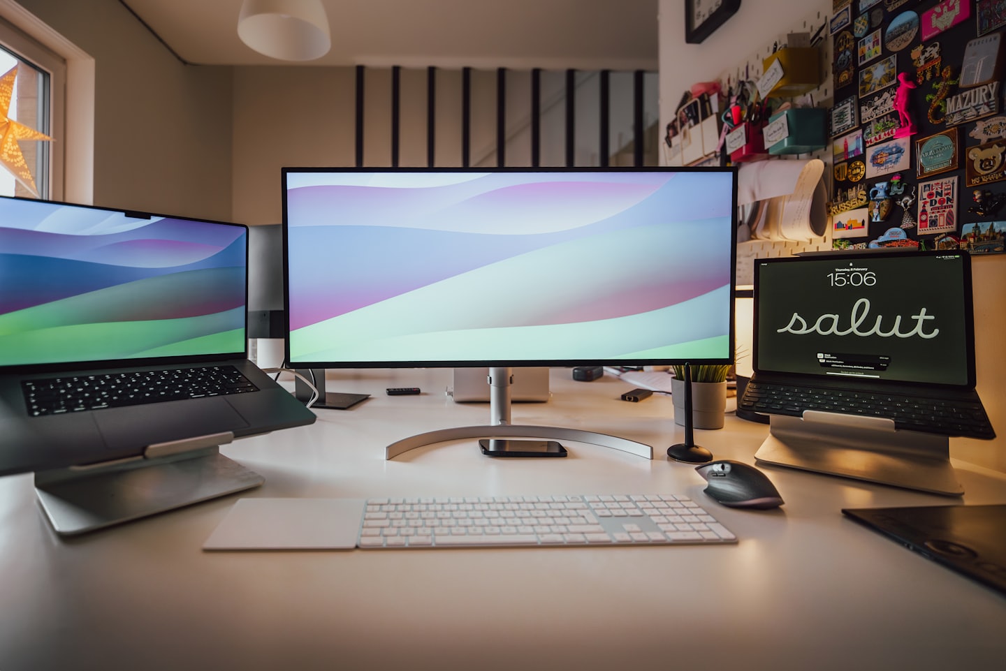 Organized desk with laptop, monitor, and tablet for digital work.